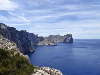 Rock formations in sea against sky