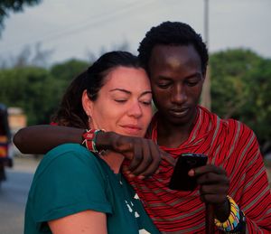 Portrait of happy young man using mobile phone