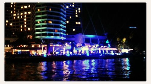 Reflection of illuminated buildings in city at night