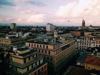 Cityscape against cloudy sky