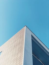 Low angle view of modern building against clear blue sky