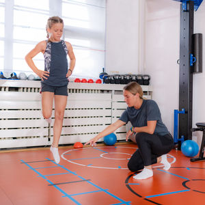 Coordination and agility exercise for children, skipping through agility ladder