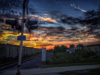 Railroad station platform against cloudy sky