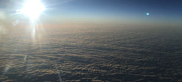 Scenic view of bright sun over land