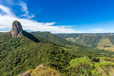 Scenic view of mountains against blue sky