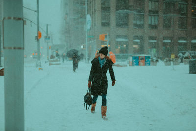 Full length of woman walking in snow
