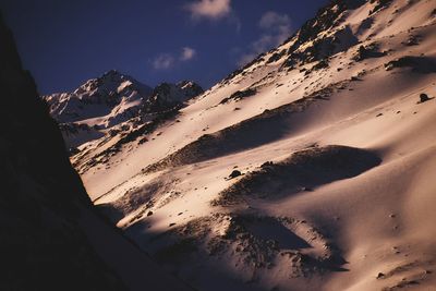 Scenic view of snowcapped mountains against sky during sunset