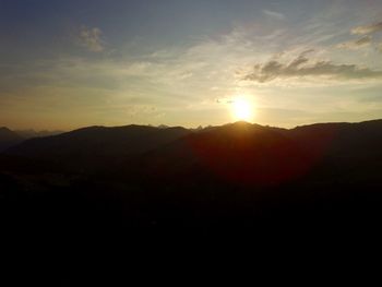 Scenic view of silhouette mountains against sky during sunset