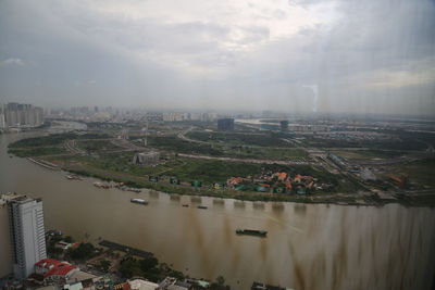 High angle view of river amidst buildings in city