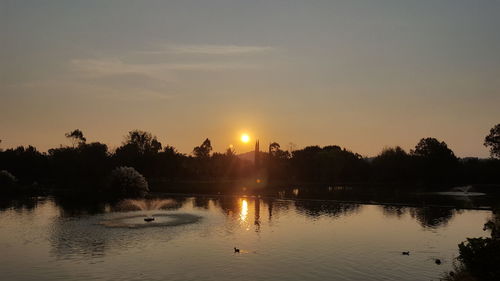 Scenic view of lake against sky during sunset