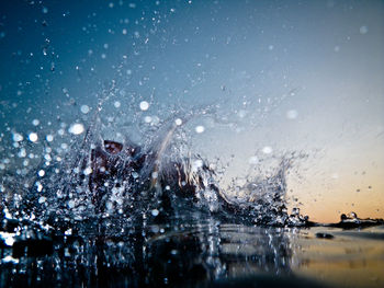 Water splashing in sea against sky