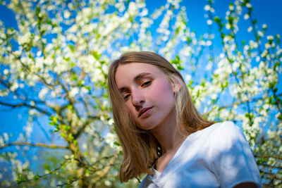 Portrait of a young woman against plants