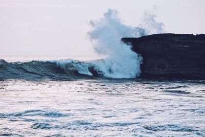 Waves breaking against sea