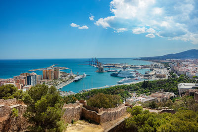 High angle view of townscape by sea against sky