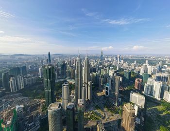 High angle view of modern buildings in city against sky