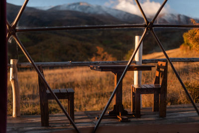 Wooden table and chairs on the veranda overlooking the mountains in autumn