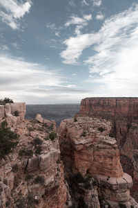 Rock formations on landscape against sky