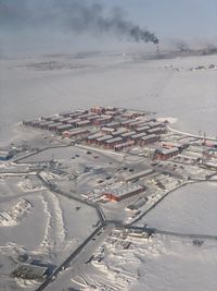 High angle view of snow covered cityscape against sky