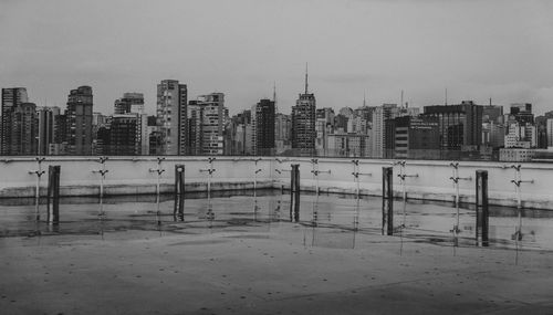 Buildings in city against sky during winter