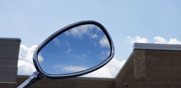 Low angle view of glass building against sky