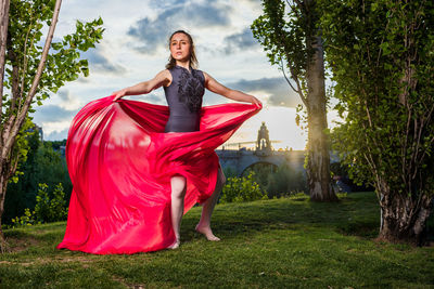 Portrait of woman standing on field