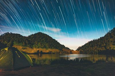Scenic view of lake against sky at night