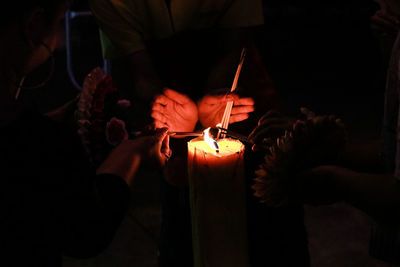 People holding lit candles