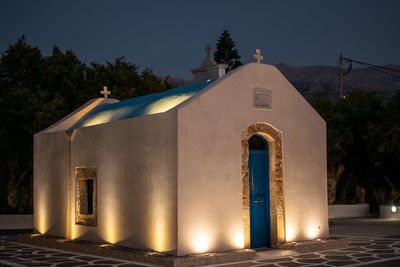 Illuminated building against clear sky