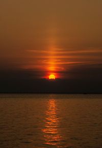 Scenic view of sea against romantic sky at sunset