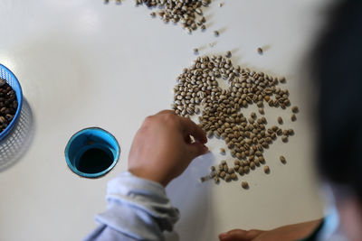Cropped hand of person holding jigsaw pieces