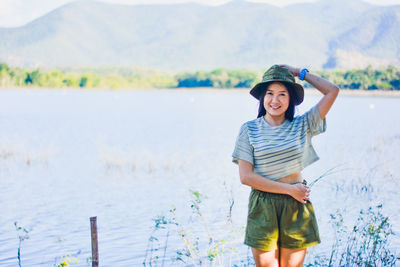 Rear view of woman standing in lake