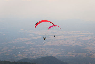 People paragliding against sky