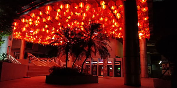 Illuminated built structure against sky at night