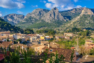 High angle view of townscape and mountains against sky