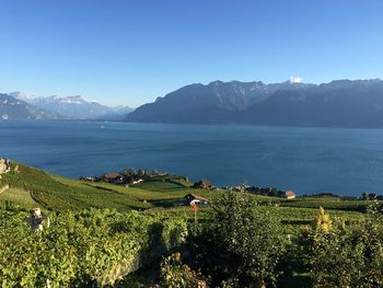 Scenic view of sea and mountains against sky