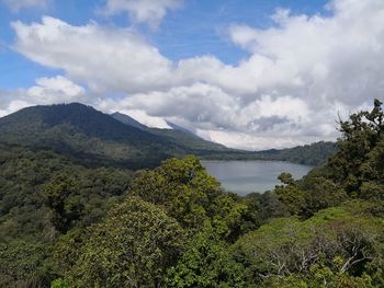 Scenic view of lake and mountains against sky