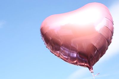 Low angle view of hot air balloon against clear blue sky