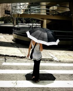 Woman standing with umbrella