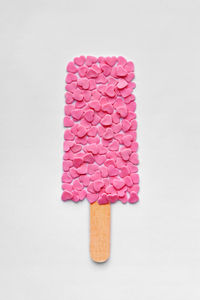 Close-up of multi colored candies against white background