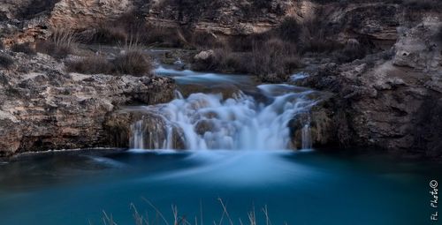 Scenic view of river flowing through rocks