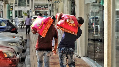 People holding umbrella on street in rainy season