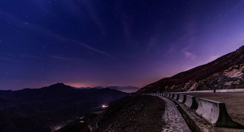 Scenic view of mountains against sky at night