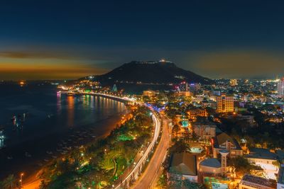 High angle view of illuminated buildings in city at night