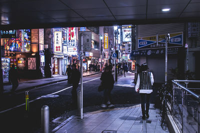 People walking in city at night