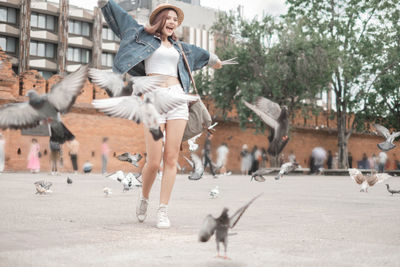 Woman with birds in city