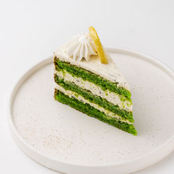 Close-up of cake on plate against white background