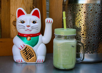 Close-up of figurine in container on table