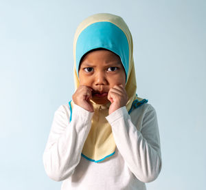 Portrait of cute boy against white background