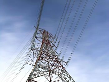 Low angle view of electricity pylon against sky