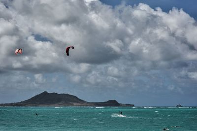 People kiteboarding on sea